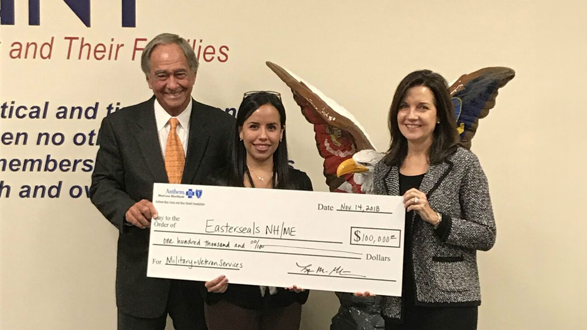 Lisa Guertin, president of Anthem Blue Cross and Blue Shield in New Hampshire (right), presents a check for a $100,000 grant to Easterseals President and CEO Larry Gammon (left) to support care coordination and emergency assistance to 1,250 veterans in New Hampshire and Maine. Joining them is Grisel DaCorte Suarez (center), a former client who, along with her husband Sid, received assistance from Easterseals’ Military & Veteran Services program prior to their marriage and after Sid’s most recent deployment. Grisel now works in the MVS program and helps other veterans and service members and their families in need.