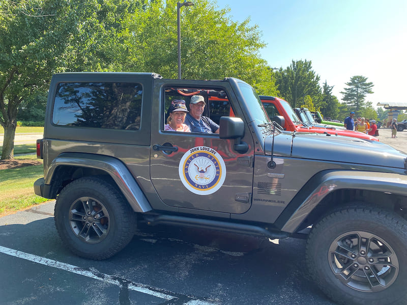 A smiling couple in a jeep with a United States Navy decal on the door is ready to roll out at last year's Veterans Count Jeepin'4Vets event. The starting location for this year’s patriotic carvan for jeep enthusiasts has been moved from Pease International Tradeport in Portsmouth to the site of Easterseals NH’s soon-to-be-built military and veterans campus in Franklin. The day will still end on the Armor Ditch trails at Harley Jacks in Ossippee. Proceeds from the 6th Annual Jeepin’4 Vets benefit NH service members, veterans, and their families.