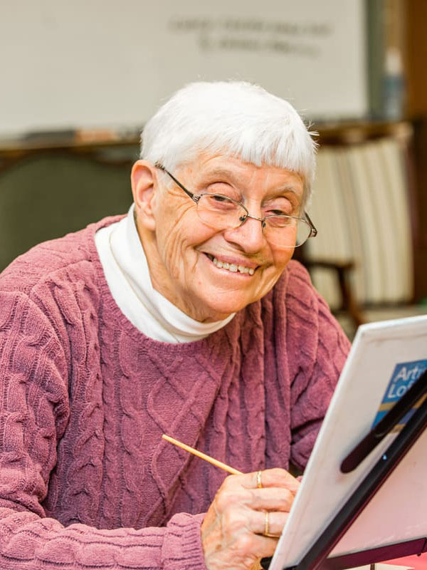 Woman painting in adult day services