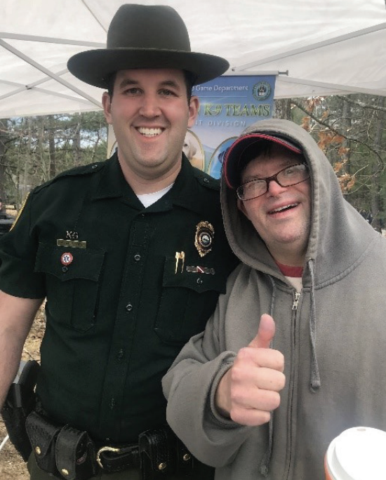 Mike, smiling and giving a thumbs up, with a NH Fish and Game officer at
Discover Wild NH Day.