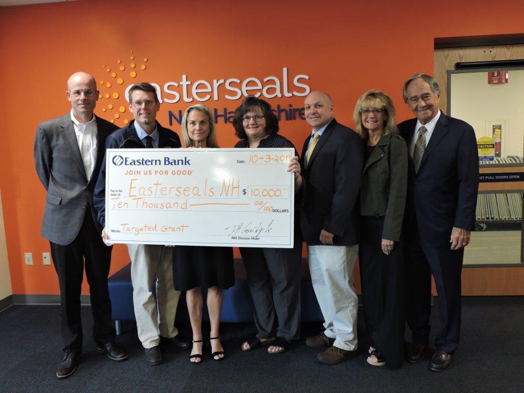 IN PHOTO: Easterseals New Hampshire and Eastern Bank representatives pose with a poster of the $10;000 check for the grant to benefit Enriching Early Childhood Development.