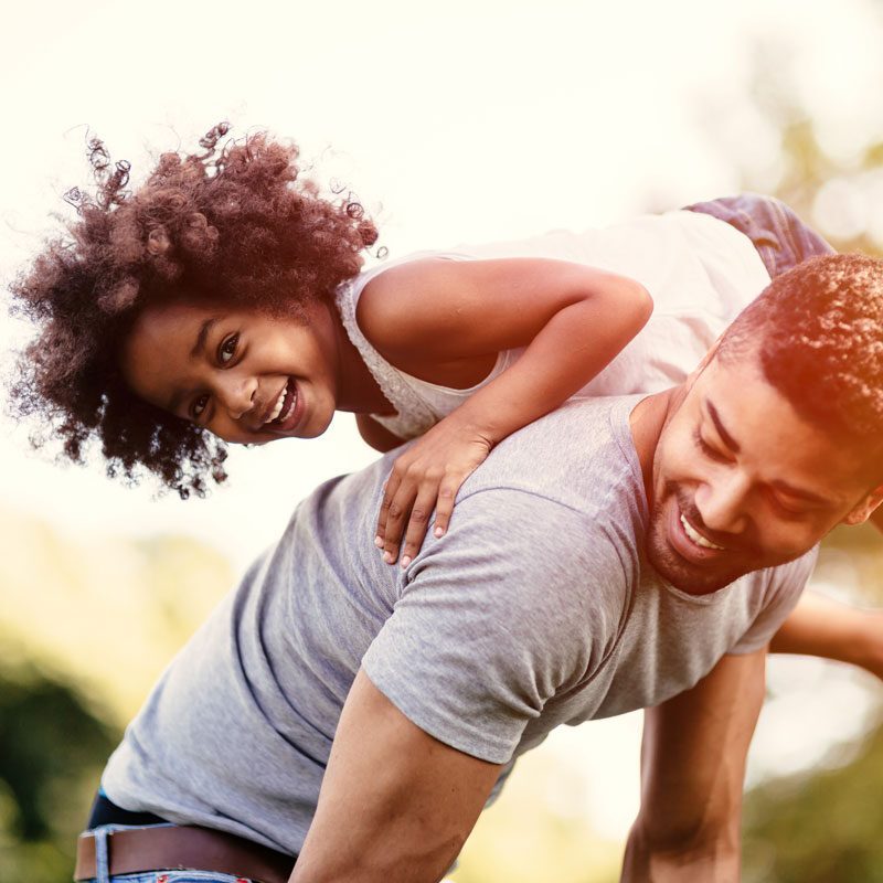 Father carrying daughter piggyback