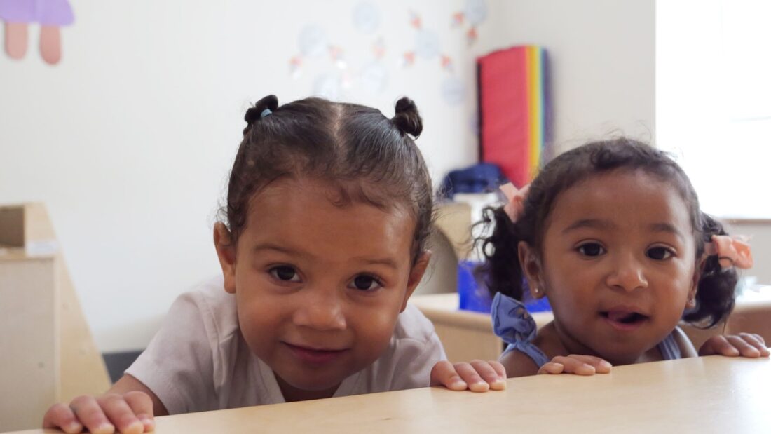 Two young girls in a classroom at Easterseals NH Child Development Center.