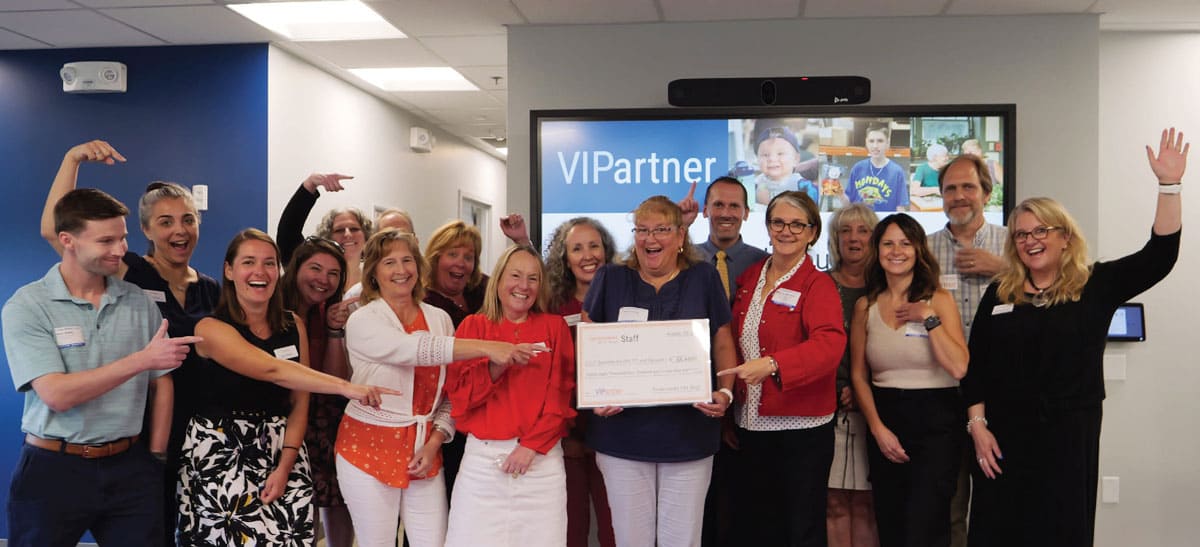 Vip staff members holding check