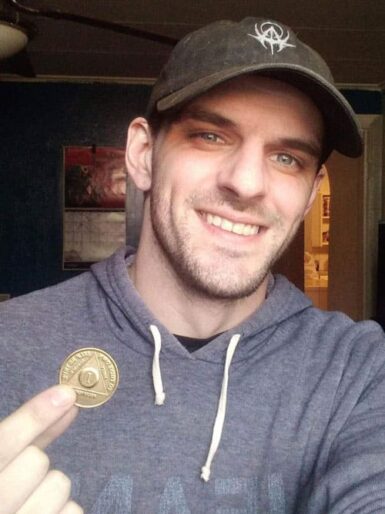 Joe holding his sobriety coin