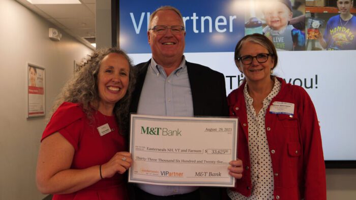 Pamela, Tim, and Maureen holding VIP check