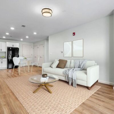 View of an apartments living room and kitchen area