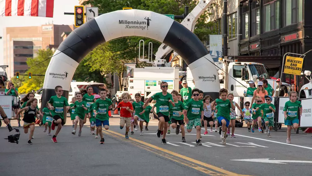 Young children running in green shirts during the Easterseals NH Eversource 5k Run and Walk event.