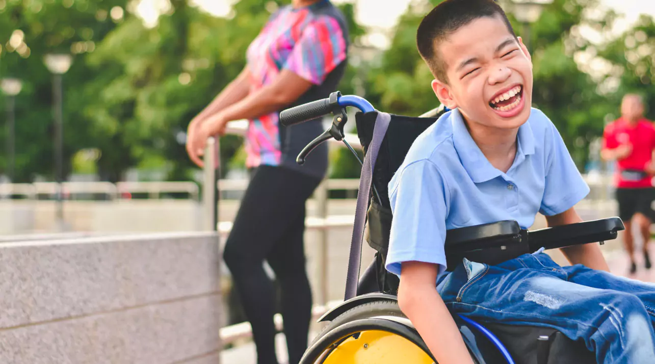 Disabled child on wheelchair is play and learn in the outdoor park like other people, Life in the education age of special children, Happy disability kid concept.