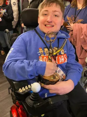 Ryan on his birthday holding a trophy.