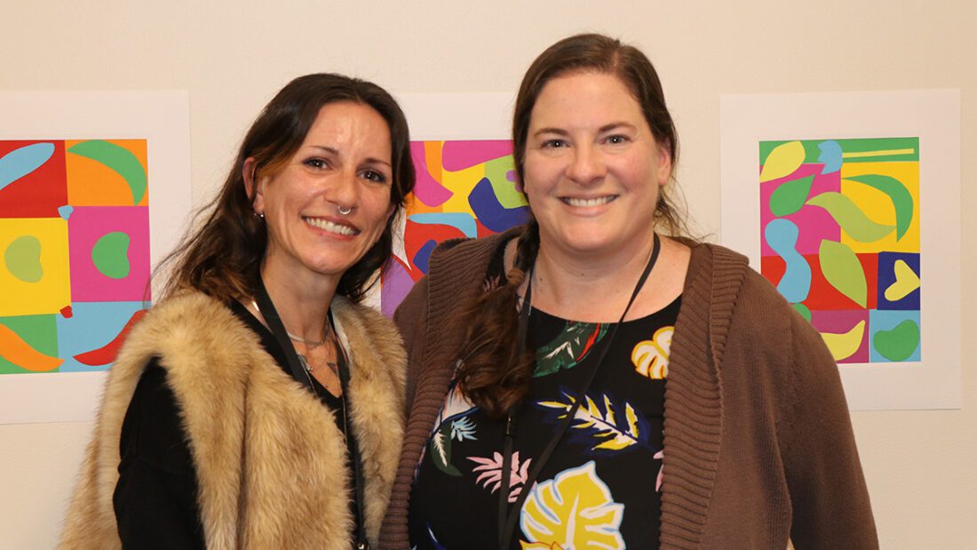 The Currier Museum of Art’s Administrative Manager and Art Educator, Michelle Peterson (l.), and Art and Wellness Program Manager, Corie Lyford, proudly display their Adult Day Program students’ artwork at the Adult Day Art Show.