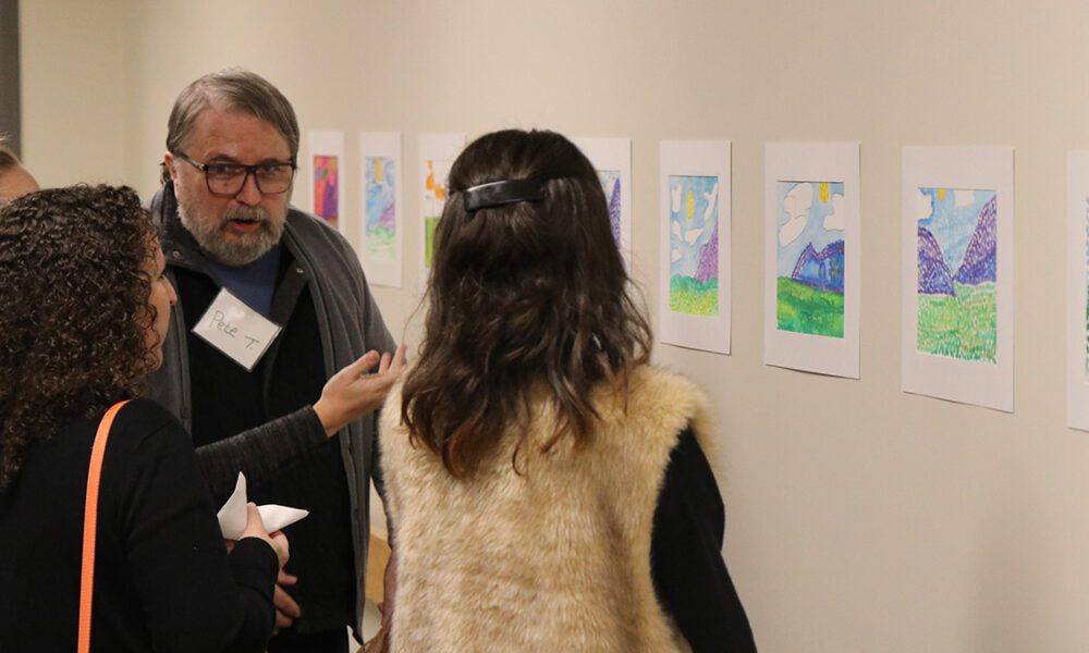 Pete, a participant in our Adult Day Program, shows off his artwork at the Adult Day Art Show