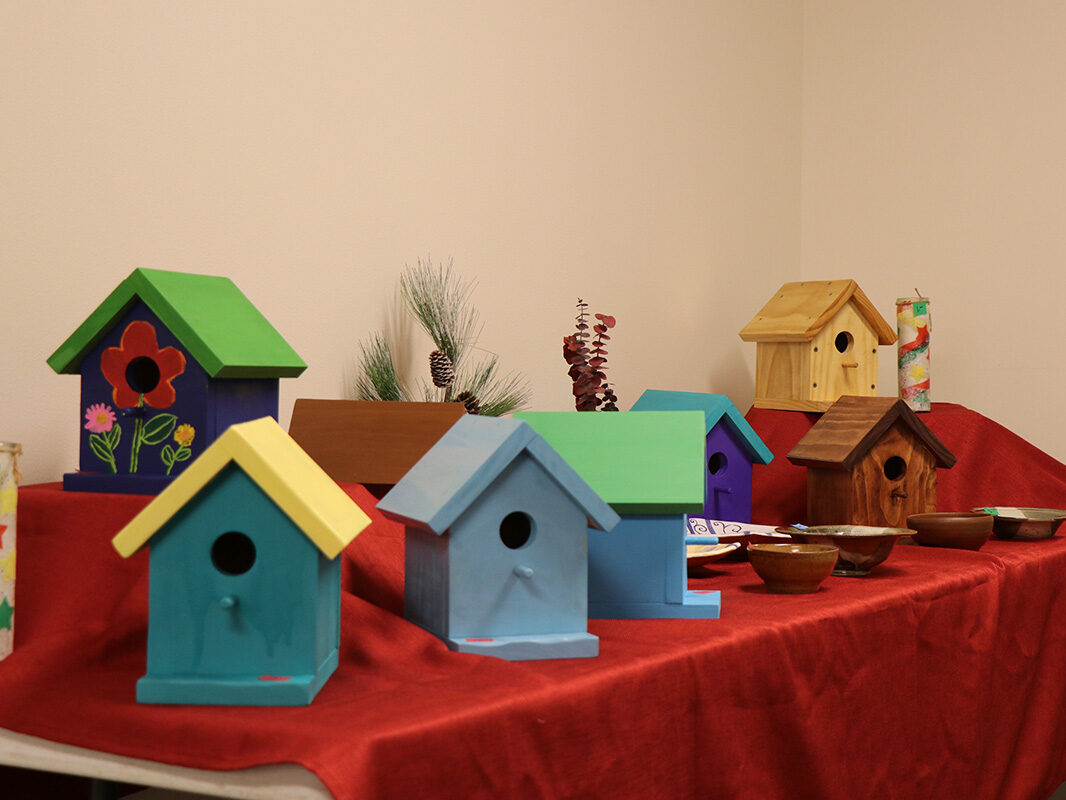 Birdhouses on a table at a holiday craft fair.