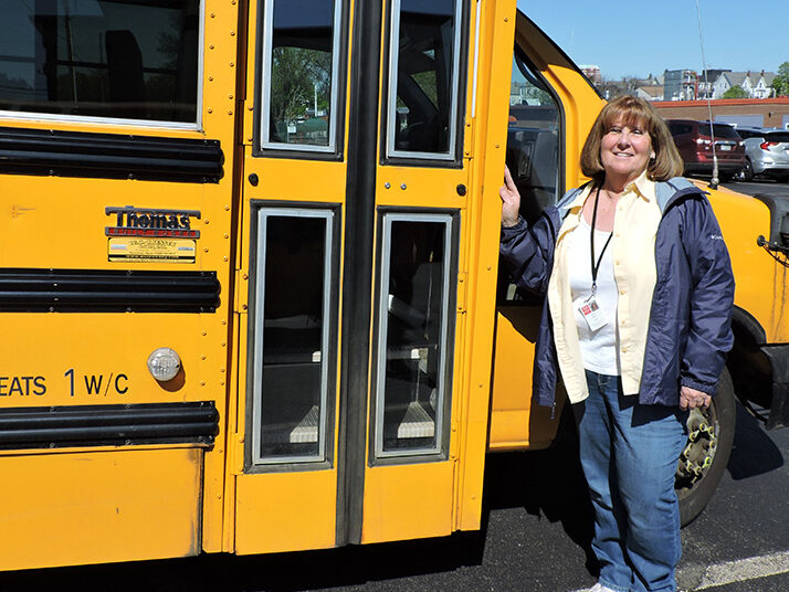 Easterseals NH bus driver standing outside bus door.