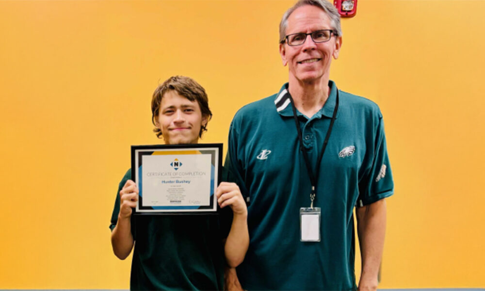 Hunter holding certificate