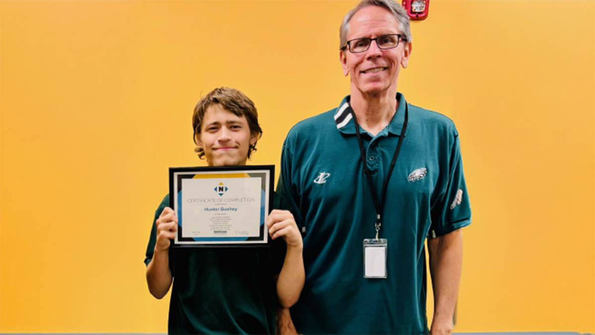 Hunter holding certificate