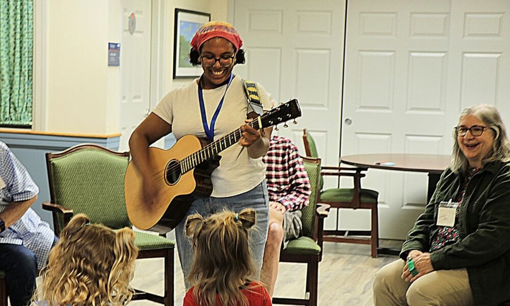 Manchester Community Music School member playing guitar