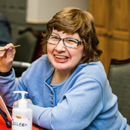 Adult day client colleen painting at Easterseals NH adult day