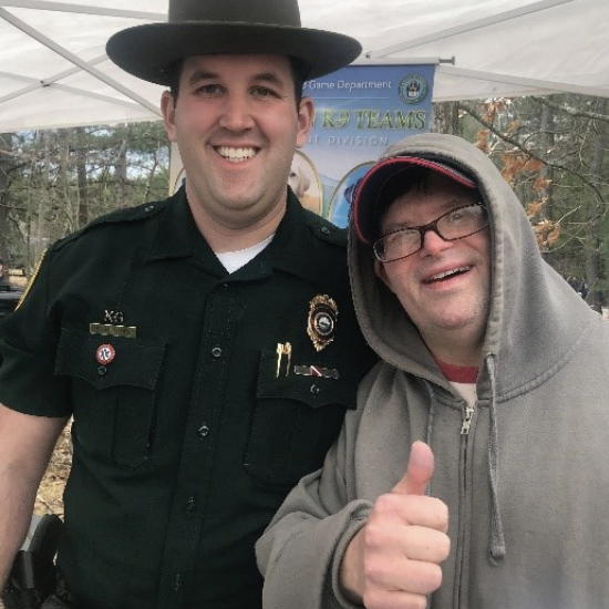 Mike, smiling and giving a thumbs up, with a NH Fish and Game officer at Discover Wild NH Day.