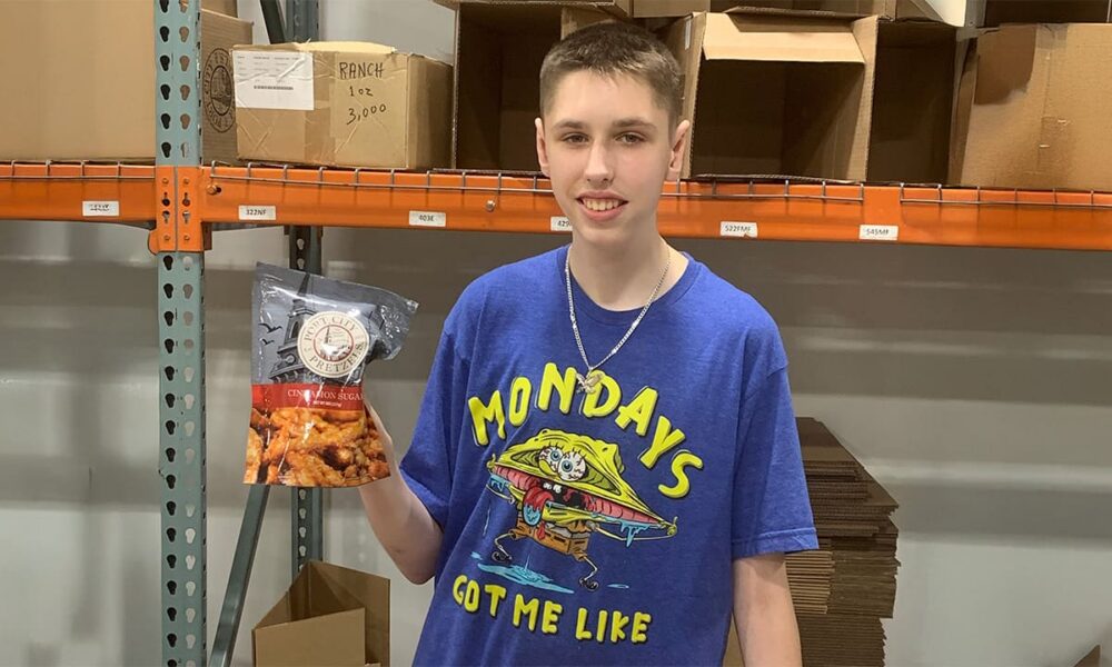 Aydan holding up a bag of port city pretzels