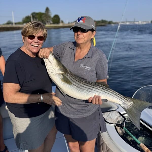President and CEO of Easterseals NH & VT, holding an incredible catch at a Striped Bass Tournament