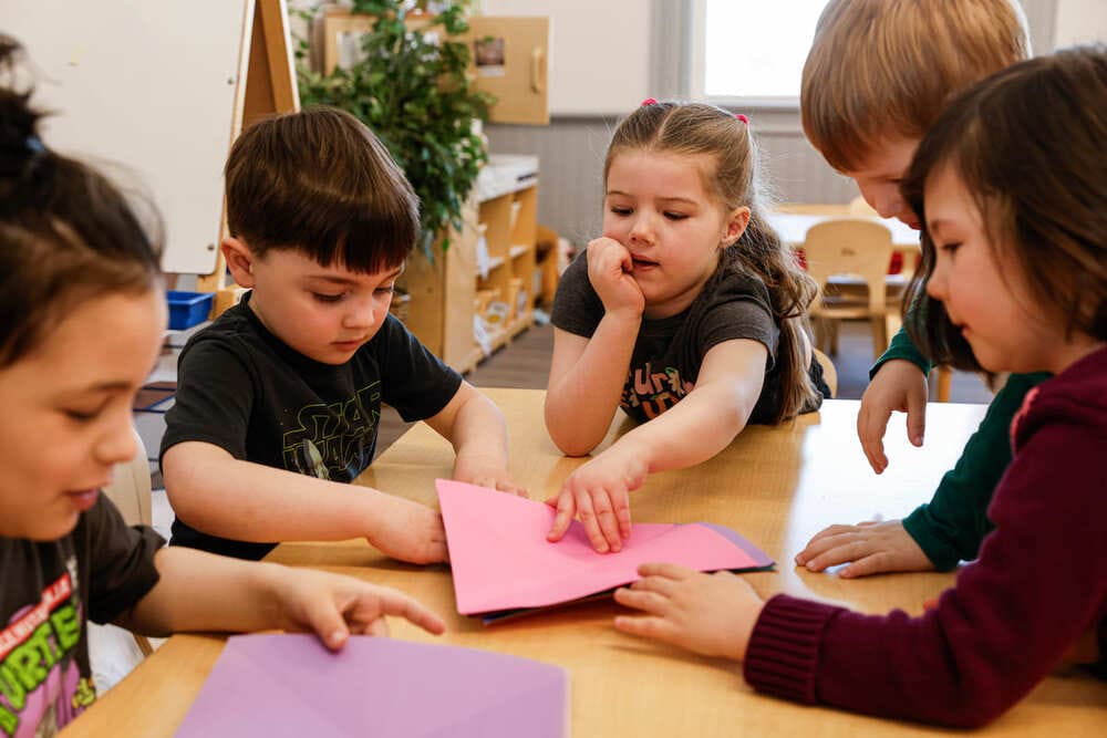 children working on group project in   classroom 
