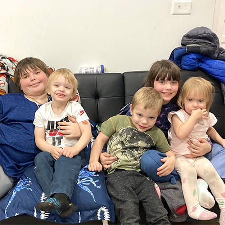 Five children sitting on a couch